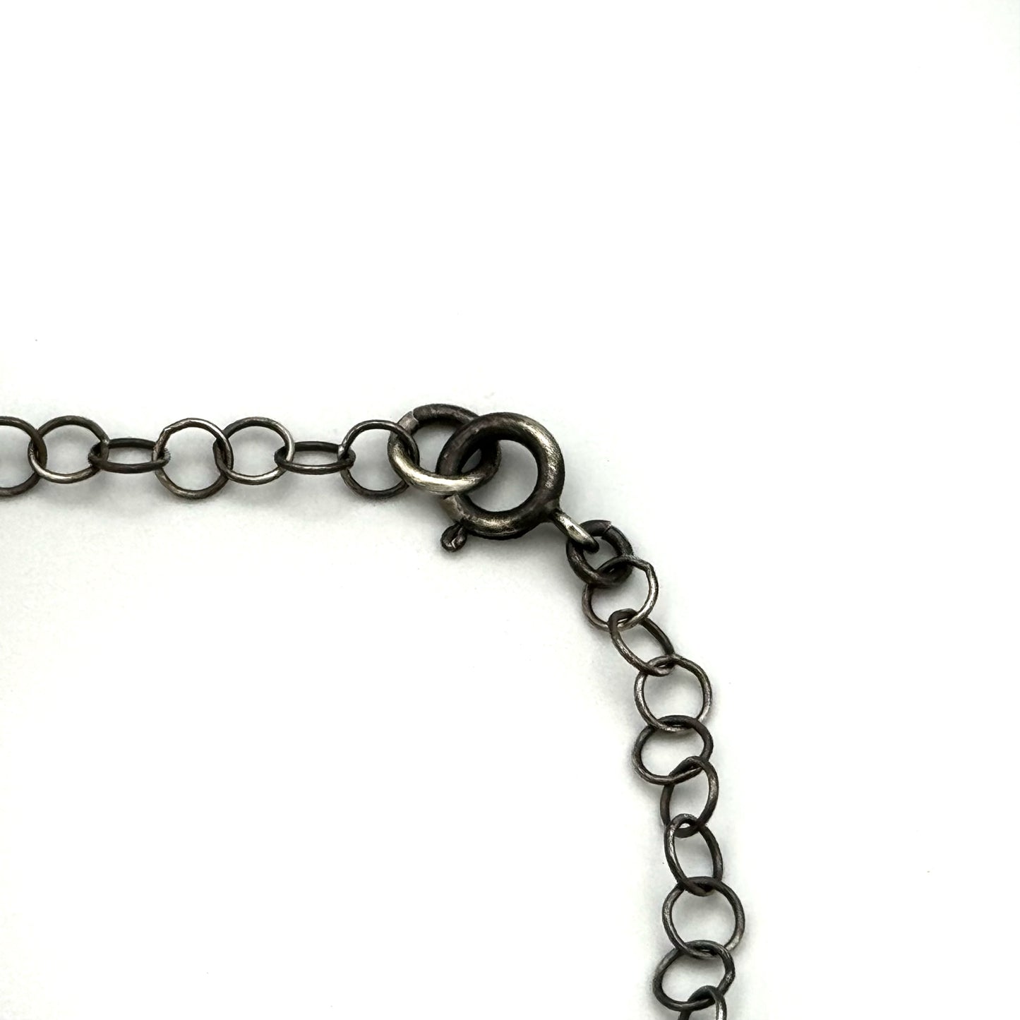 Silver and brass hand pierced pendant with onyx.