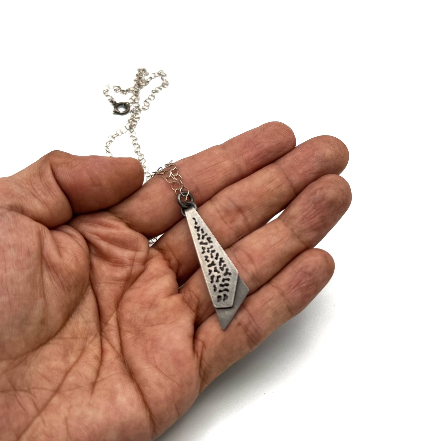 Hand pierce oxidize, silver pendant.