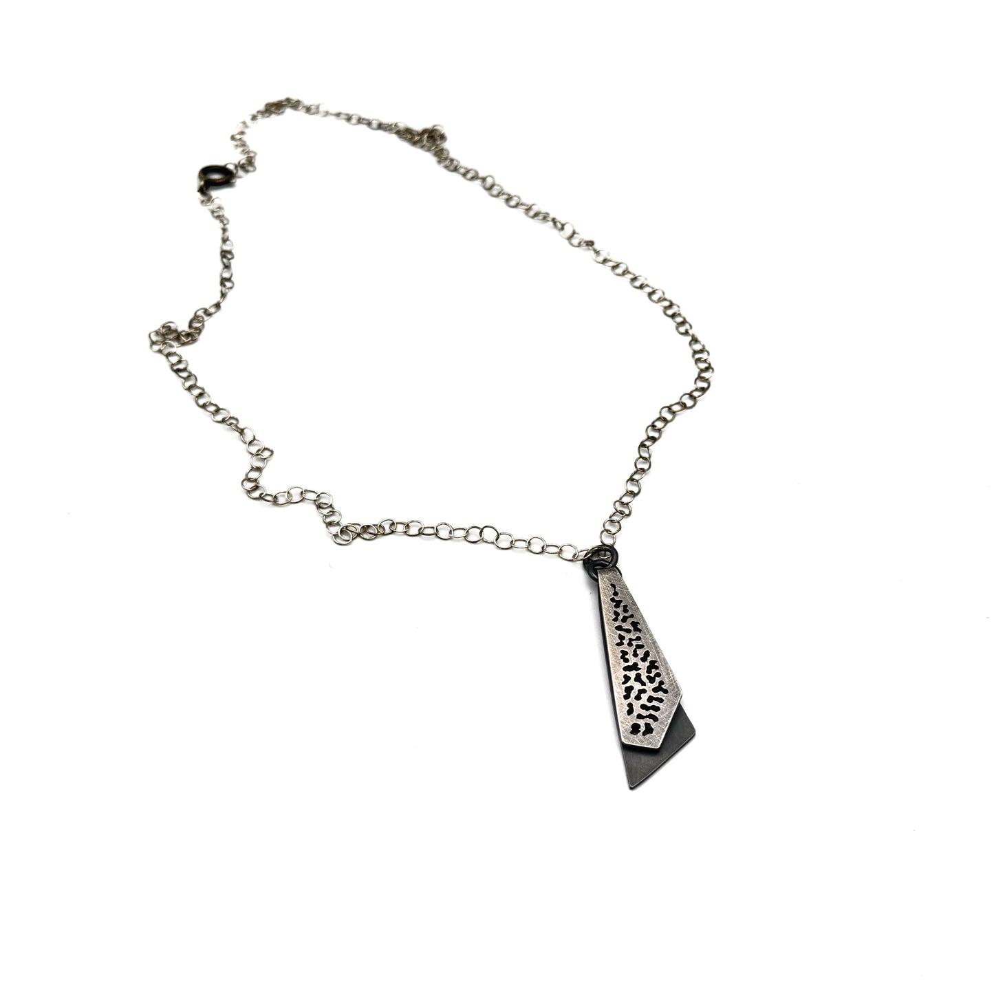 Hand pierce oxidize, silver pendant.