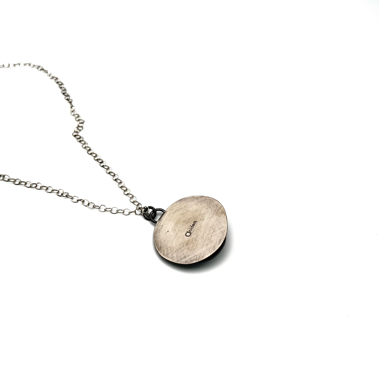 Hand pierced oxidize, silver pendant.