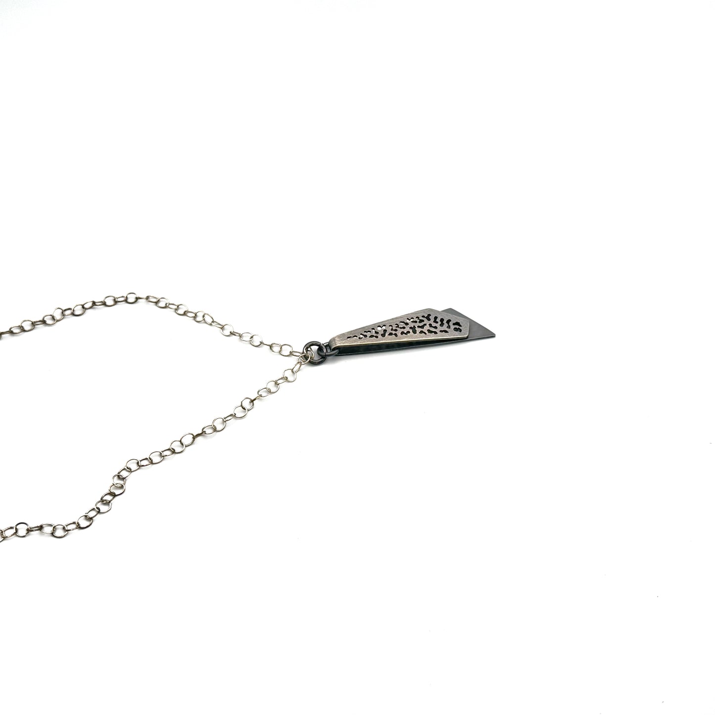 Hand pierce oxidize, silver pendant.