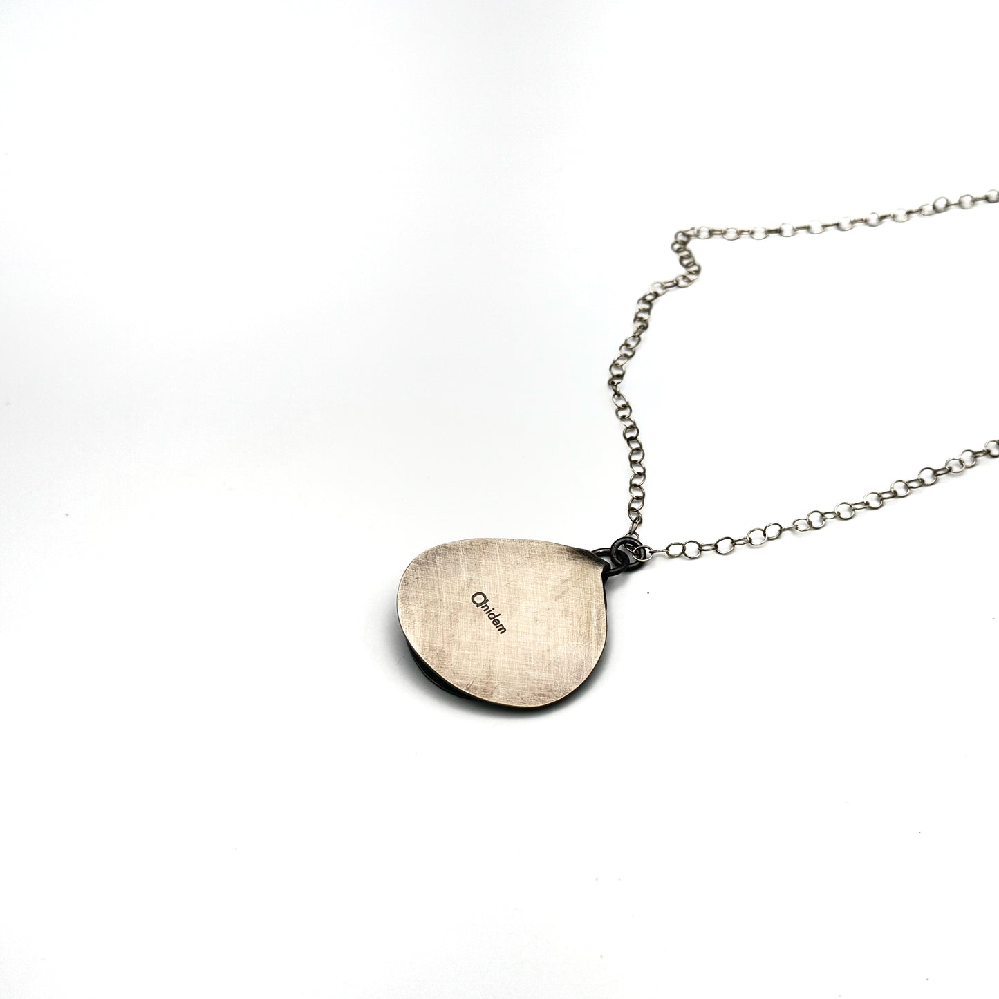 Hand pierce silver pendant.