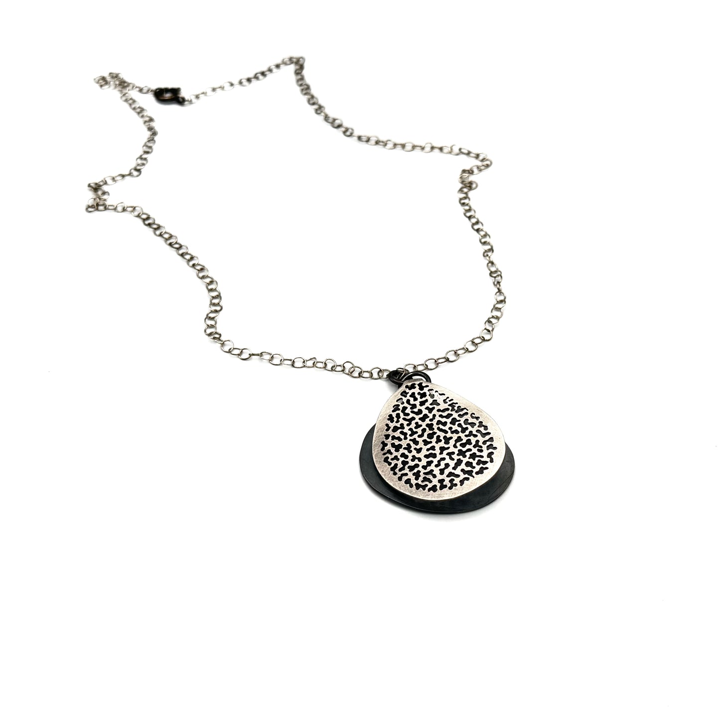 Hand pierce silver pendant.