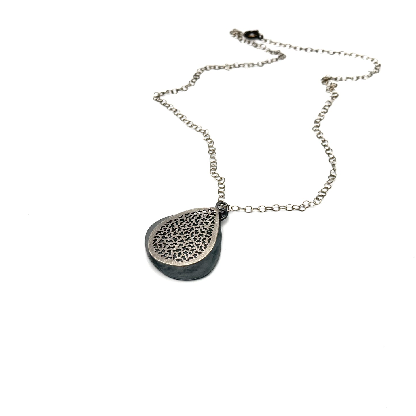 Hand pierce silver pendant.
