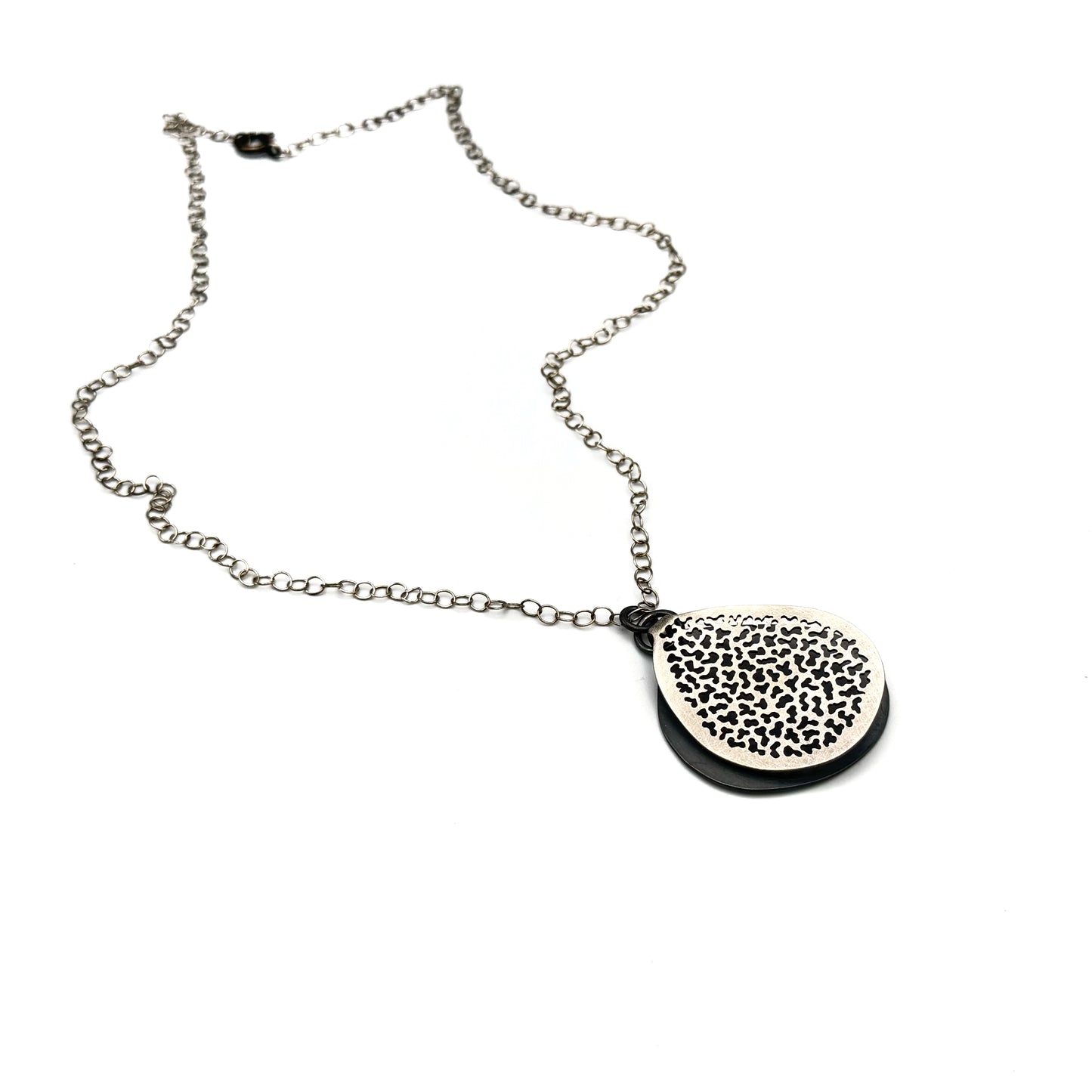 Hand pierce silver pendant.